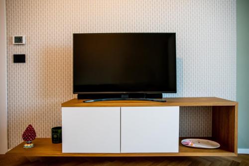 1. Mobile TV sospeso con rivestimento in rovere e ante laccate-min